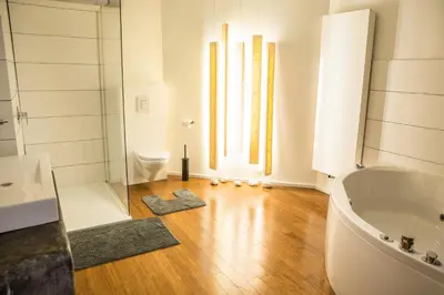 a bathroom with a tub and a sink and a toilet at BNB Nest in Ghent