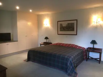 a hotel room with a bed and a tv at Bossenstein Golf & Polo Club in Ranst