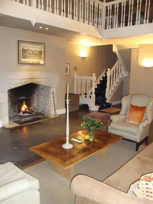 a living room with a fireplace and a table at Bossenstein Golf & Polo Club in Ranst