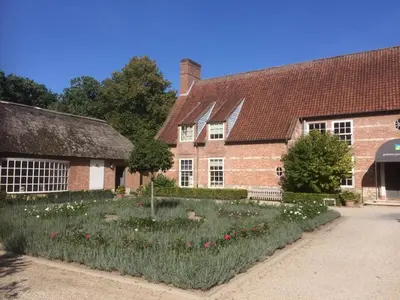 an old house with a garden in front of it at Bossenstein Golf & Polo Club in Ranst