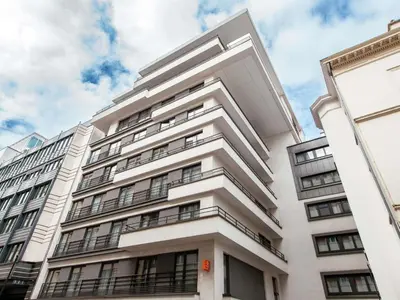 a white building with balconies on the side of it at Aparthotel Adagio Access Bruxelles Europe Aparthotel in Brussels