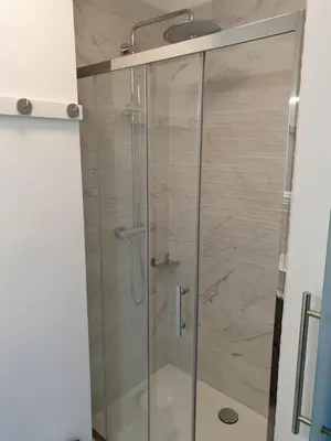 a shower with a glass door in a bathroom at B&B Luxe Suites 1-2-3 in Antwerp