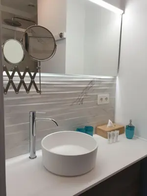 a bathroom with a sink and two mirrors on a counter at B&B Luxe Suites 1-2-3 in Antwerp