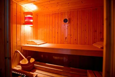 a wooden sauna with a bench in the middle at B&B Luxe Suites 1-2-3 in Antwerp