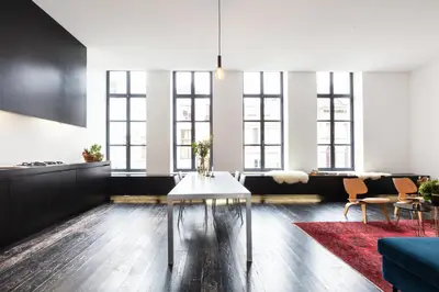 a living room with a table and some chairs at Josie in Ghent