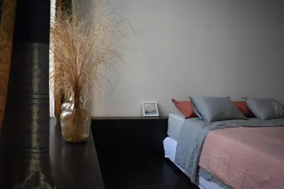 a living room with a couch and a vase on a table at Josie in Ghent
