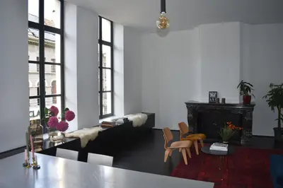 a living room with a couch and a fireplace at Josie in Ghent