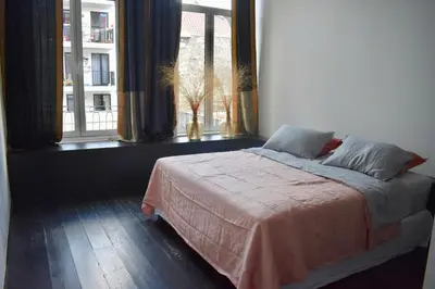 a bedroom with a bed and a window with a view at Josie in Ghent