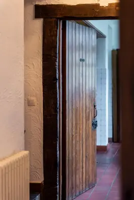a wooden door in a room with a tile floor at Rose House B&B in Ghent