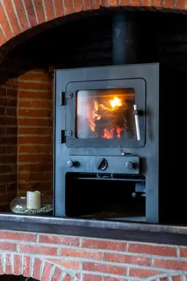 a brick oven with a fire inside of it at Rose House B&B in Ghent
