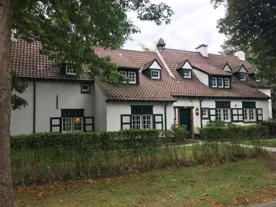 a white house with a red roof at Rose House B&B in Ghent