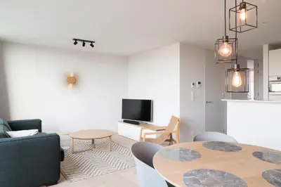 a living room with a couch and a table at Skyline Flats Gent in Ghent