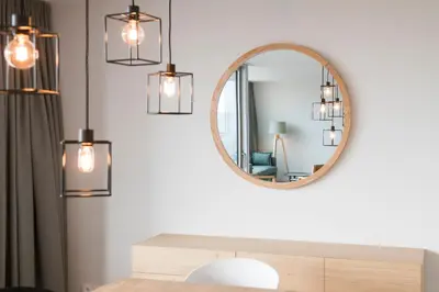 a living room with a mirror and a table at Skyline Flats Gent in Ghent