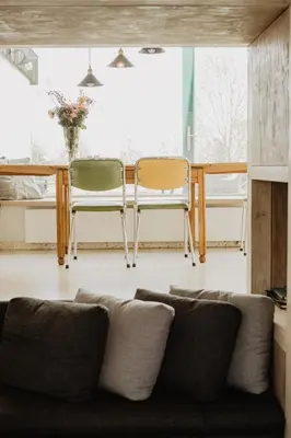 a living room with a couch and two chairs at Huisje Nummer Tien in Sint-Laureins