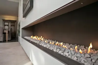 a stone fireplace in a wall with fires on it at Puur B&B in Antwerp