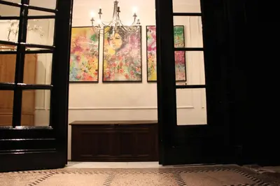 a room with paintings on the wall and a chandelier at Puur B&B in Antwerp