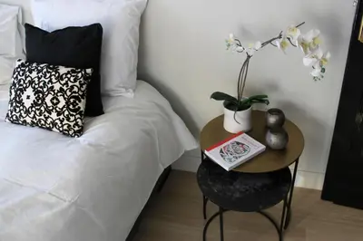 a bedroom with a bed and a table with a book at Puur B&B in Antwerp