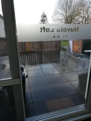 a glass door with the words hot shower on it at Nuvola Loft in Zottegem
