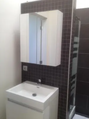 a bathroom with a white sink and a mirror at Nuvola Loft in Zottegem