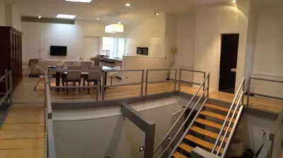 a room with a table and a dining room at Nuvola Loft in Zottegem