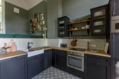 a kitchen with blue cabinets and a sink at Antonine's Atelier in Hingene