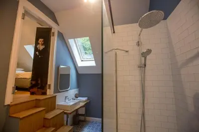 a bathroom with a shower and a sink at Antonine's Atelier in Hingene