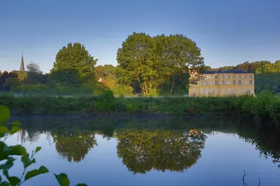 a reflection of a building in a body of water at Antonine's Atelier in Hingene