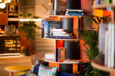 a stack of books on a book shelf at YUST Antwerp in Antwerp
