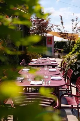 a long table with plates and glasses on a patio at YUST Antwerp in Antwerp
