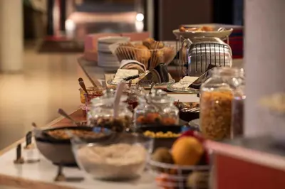a counter with a bunch of food in jars on it at YUST Antwerp in Antwerp