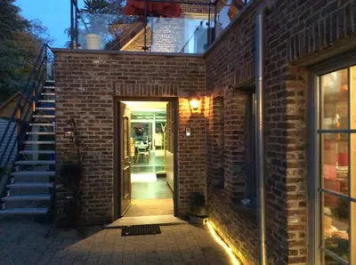 a brick building with a door leading into a hallway at Biotina in Lebbeke