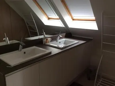 a bathroom with two sinks and a mirror at Biotina in Lebbeke