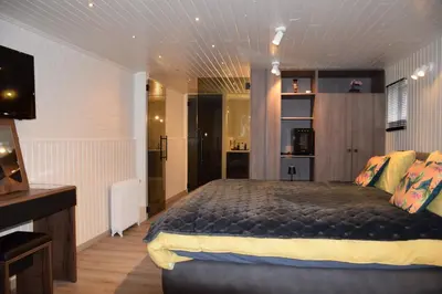 a bedroom with a large bed in a room at Biotina in Lebbeke