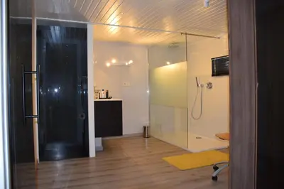a bathroom with a shower and a glass door at Biotina in Lebbeke
