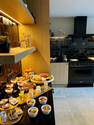 a kitchen with many plates of food on a table at B&B Ginnekenshoeve in Beerse
