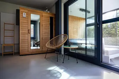 a living room with two chairs and a tub at B&B Ginnekenshoeve in Beerse