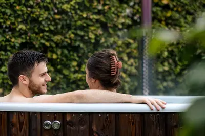 a man and a woman in a bathtub at B&B Ginnekenshoeve in Beerse