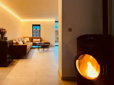a living room with a couch and a fire place at B&B Ginnekenshoeve in Beerse