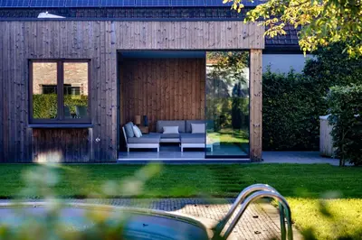 a backyard with a couch and a patio at B&B Ginnekenshoeve in Beerse