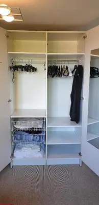 a walk in closet with white doors and shelves at Be.Cosy in Brussels