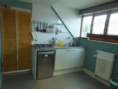 a small kitchen with a stove and a sink at Be.Cosy in Brussels