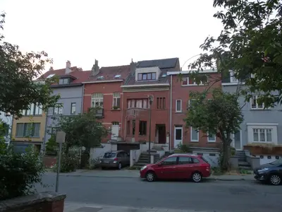 a red car parked in front of a building at Be.Cosy in Brussels
