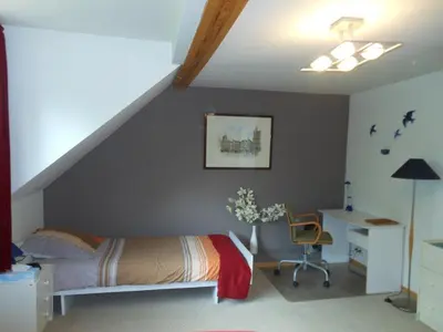 a bedroom with a bed and a desk with a chair at Be.Cosy in Brussels