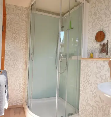 a glass shower in a bathroom with a sink at Be.Cosy in Brussels