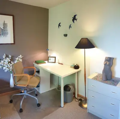 an office with a desk and a lamp and a chair at Be.Cosy in Brussels