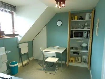 a small room with a table and a microwave at Be.Cosy in Brussels