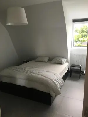 a bedroom with a bed and a window at Casa Akuta Airport Flat in Kortenberg