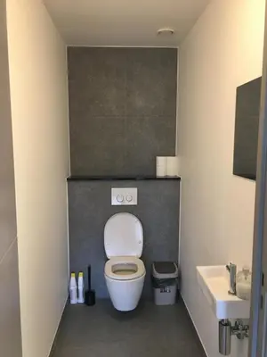 a small bathroom with a toilet and a sink at Casa Akuta Airport Flat in Kortenberg