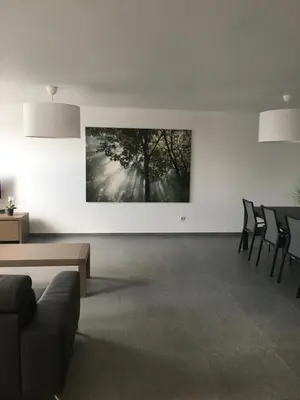 a living room with chairs and a painting on the wall at Casa Akuta Airport Flat in Kortenberg