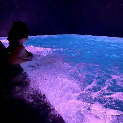 a young child sitting in a pool of water at Harmon House - Hotel & Spa in Brussels